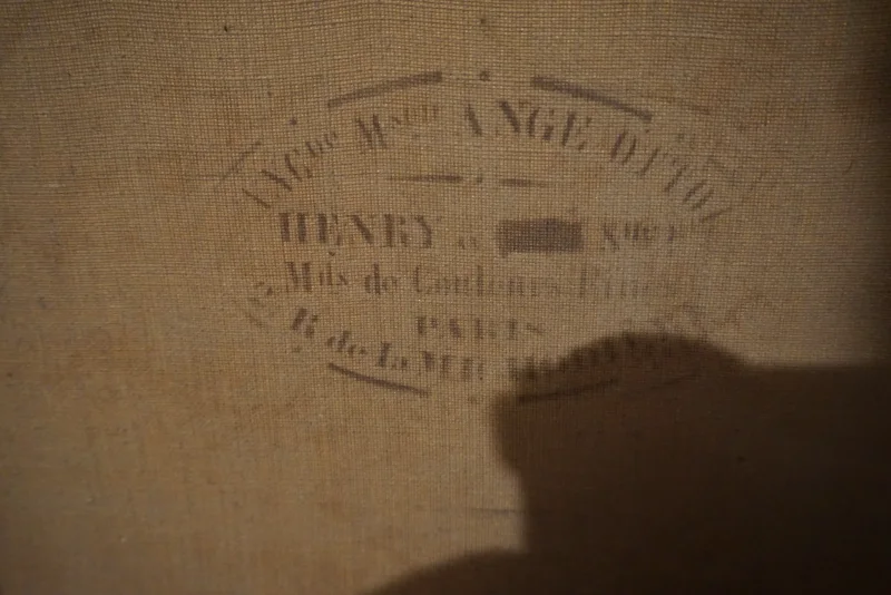 Close-up of the circular canvas supplier stamp on the reverse, reading Henry, Paris, French art supplier mark