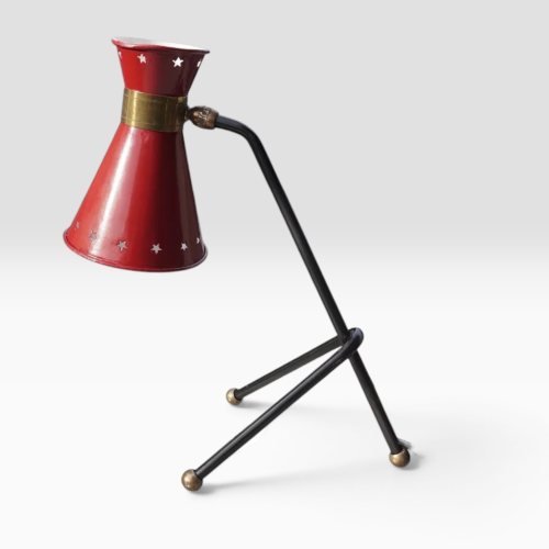 Red star-perforated conical shade on black lacquered tripod base with brass ball feet, attributed to René Mathieu for Maison Lunel