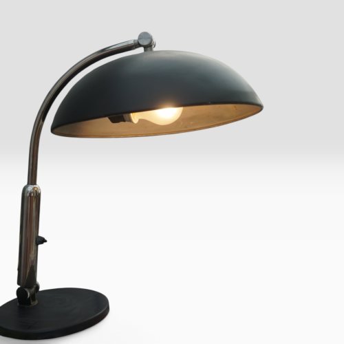 Black lacquered dome desk lamp by Hala Zeist, model 144, with adjustable arm and weighted round base, lit